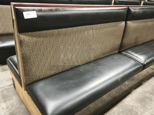 Mid-channeled style restaurant booth with headroll, featuring black upholstery and patterned back. Tag number 239 visible.