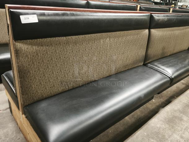 Mid-channeled style restaurant booth with headroll, featuring textured back, black vinyl seat, and numbered tag "239." Good condition.