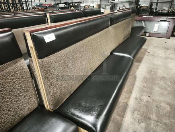 Mid-channeled style restaurant booth with headroll; black vinyl seat, patterned fabric back, wood trim, tag "241."