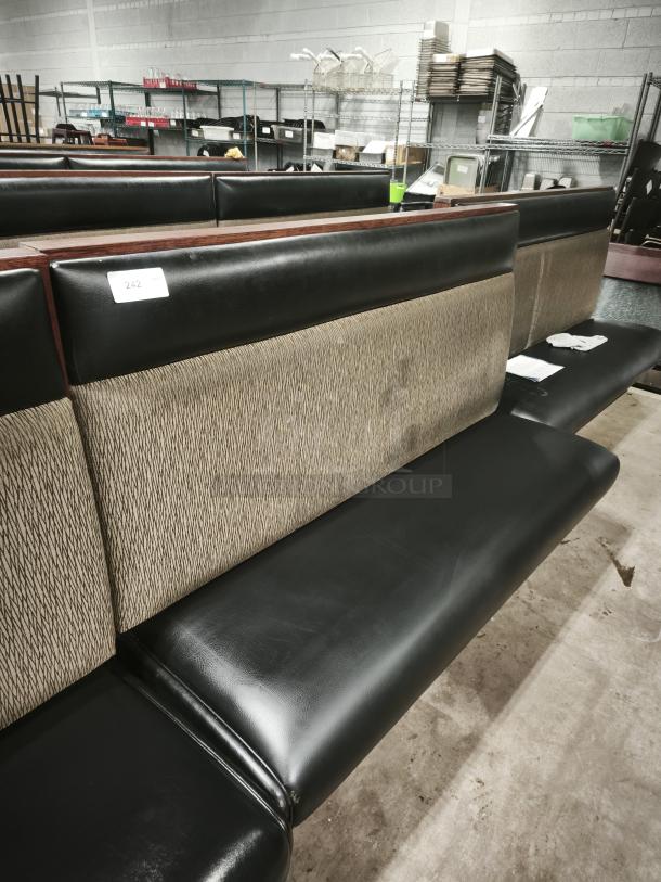 Mid-channeled style restaurant booth with headroll, black leather seat, patterned fabric backrest, label reads "242".