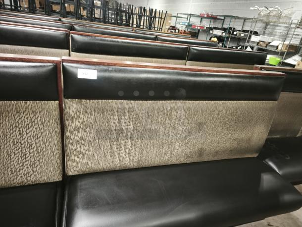 Mid-channeled restaurant booth with headroll, featuring black upholstery and patterned backrest. Condition appears used. Label reads "242."