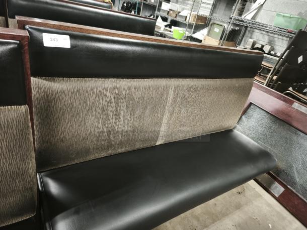 Mid-channeled restaurant booth with headroll, black leather seat, textured backrest, tag "243 GTY", good condition.