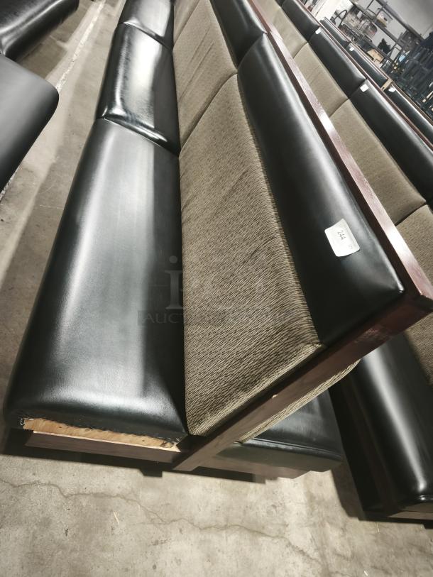 Double mid-channeled restaurant booth with headroll, black and beige upholstery, visible wear at the base, tag marked "244".