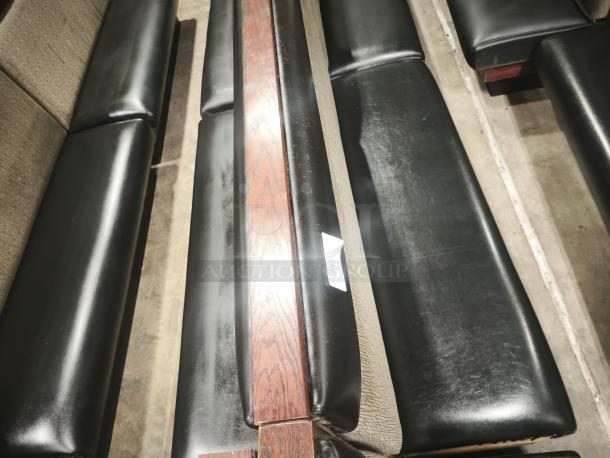 Double mid-channeled restaurant booth with headroll, black leather upholstery, wood trim. Number label visible. Good condition.