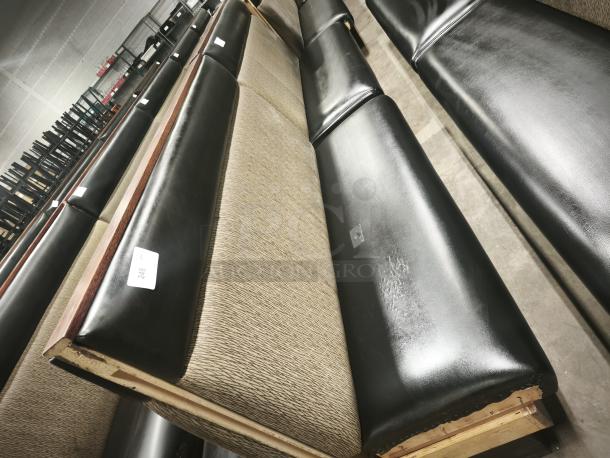 Double mid-channeled restaurant booth with headroll, shown in good condition. Black and beige upholstery, slight wear visible.