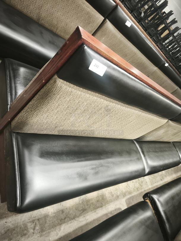 Double mid-channeled style restaurant booth with headroll, dark leatherette seating, wood frame, good condition, tag showing "249".