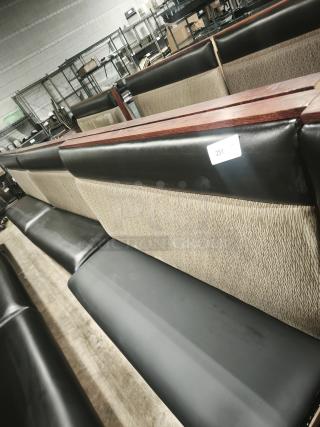 Single mid-channeled restaurant booth with headroll, beige and black upholstery, wooden accents, tag numbered 251.