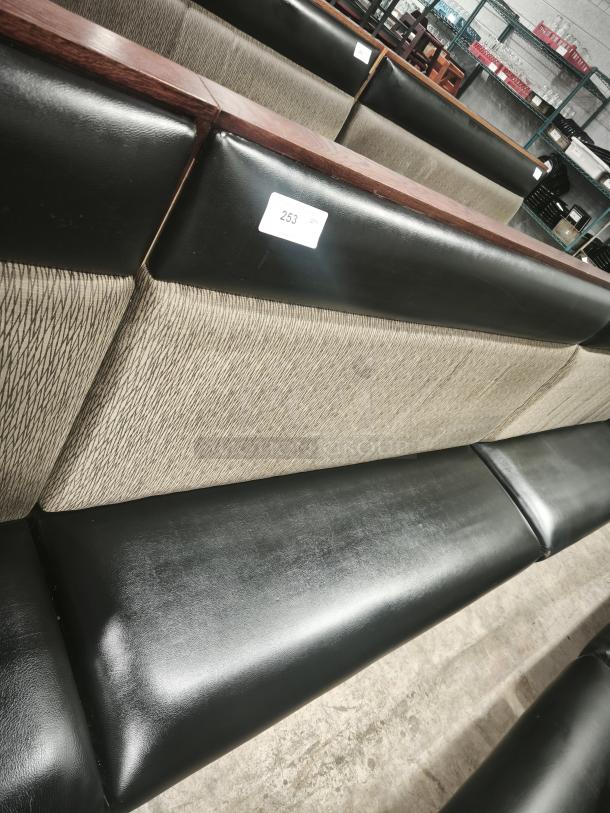 Double mid-channeled style restaurant booth with headroll, featuring black and patterned upholstery, in good condition. Tag: "253".