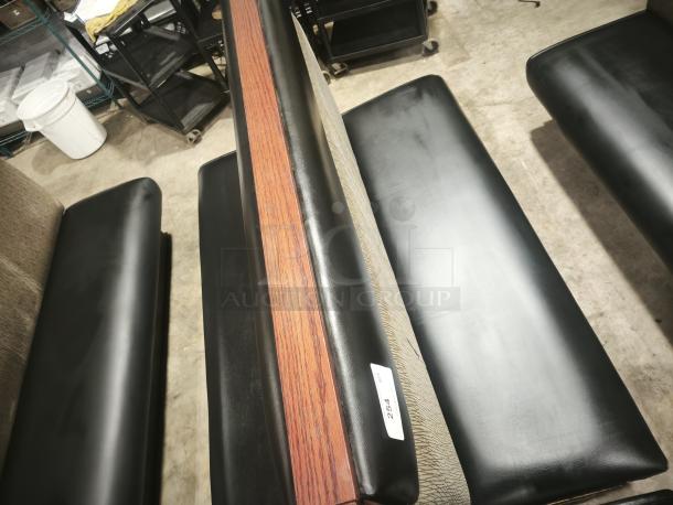 Double mid-channeled style restaurant booth with headroll, featuring black seats and a wooden backrest. Item tag reads "254."