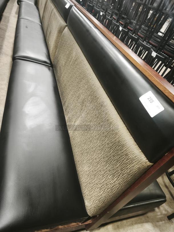 Double mid-channeled style restaurant booth with headroll, featuring black and beige upholstery, wooden frame, and good condition.