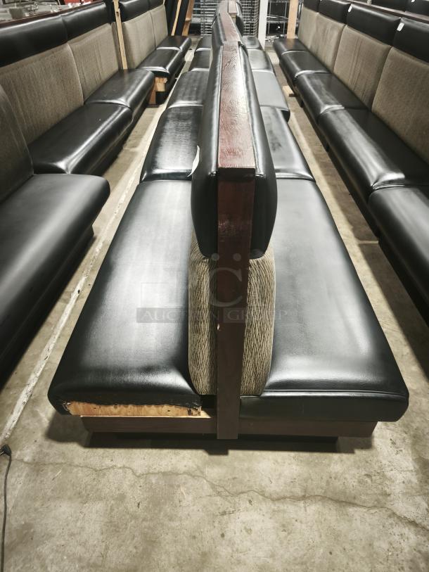 Double mid-channeled restaurant booth with headroll, black and patterned upholstery, visible wear on base, sturdy wood frame.