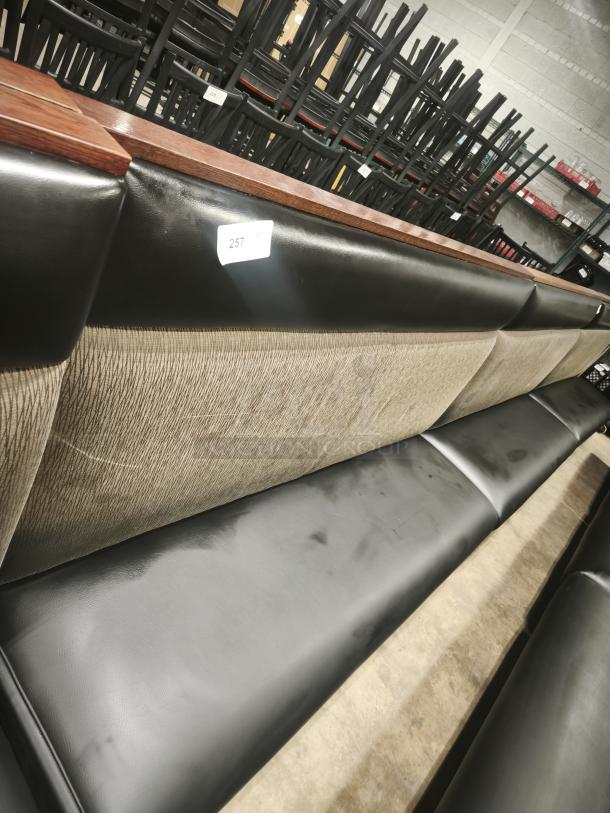 Double mid-channeled restaurant booth with headroll, features black and beige upholstery, minor wear visible, tagged with number 257.