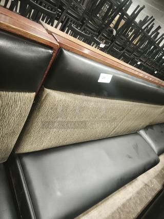 Single mid-channeled restaurant booth with headroll, black and beige upholstery, wooden accents, tag numbered 258.