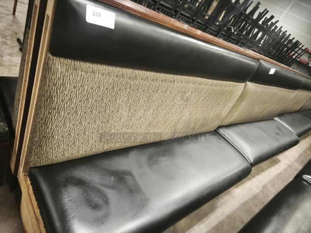 Single mid-channeled style restaurant booth with headroll, features black leather seat, patterned fabric backrest. Tag: "259".