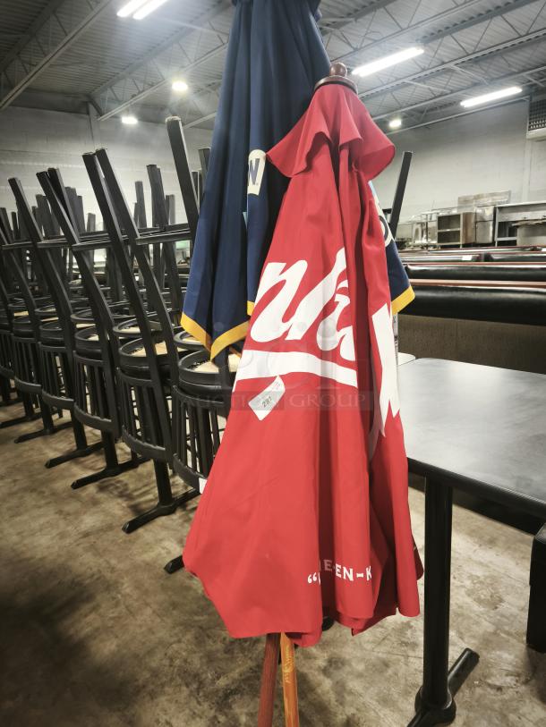 Red and blue patio beer umbrella for bar or restaurant use, good condition, numbered tag 287 visible on fabric.