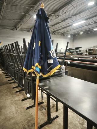 Blue patio beer umbrella for bar or restaurant, featuring logo designs. Good condition, orange pole, item tag visible.