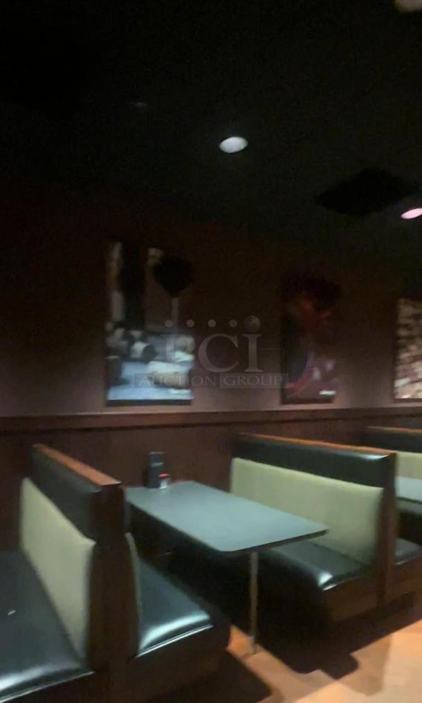 Rectangular tables paired with fixed booth seating, featuring a sleek black tabletop and cushioned seats, in good condition.