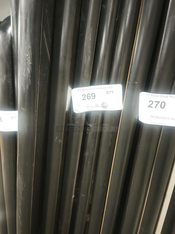 Rectangular tables for fixed booth seating, black finish, quantity 269, visible auction tags, suitable for commercial use.