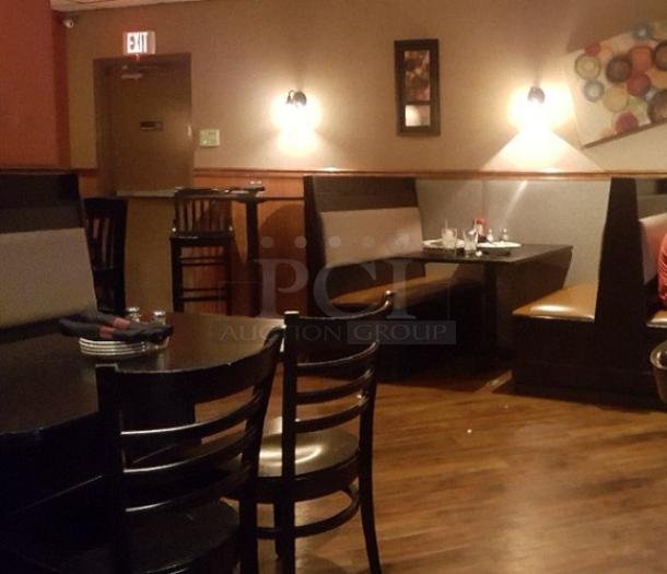 Rectangular tables with fixed booth seating in a dimly lit restaurant setting. Dark wood finish, matching chairs, and vinyl upholstery.