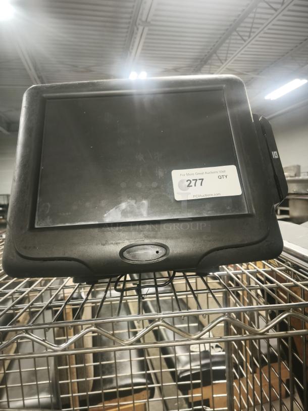 Radiant Systems POS display monitor on metal rack, used condition, visible auction label "277 QTY."