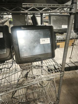 Radiant Systems POS display monitor, black, used condition, visible power cords, labeled with auction tag number 278.