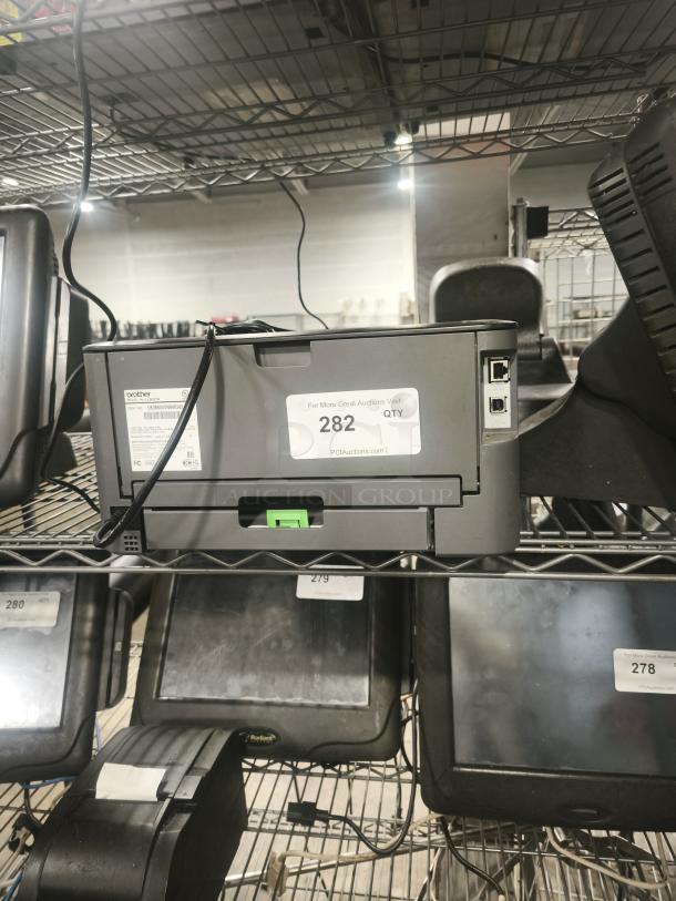 Brother HL-L2340DW Monochrome Laser Printer on shelf. Appears in good condition. Model and connectivity labels visible.