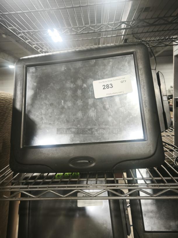 Radiant Systems POS display monitor with black frame, worn surface. Auction tag number 283 visible.