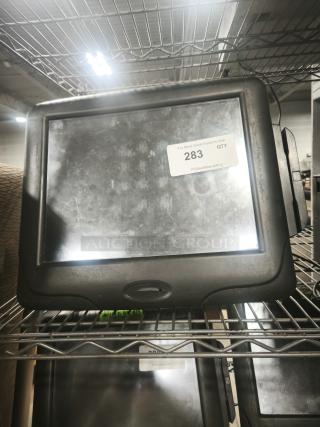 Radiant Systems POS display monitor with black frame, worn surface. Auction tag number 283 visible.