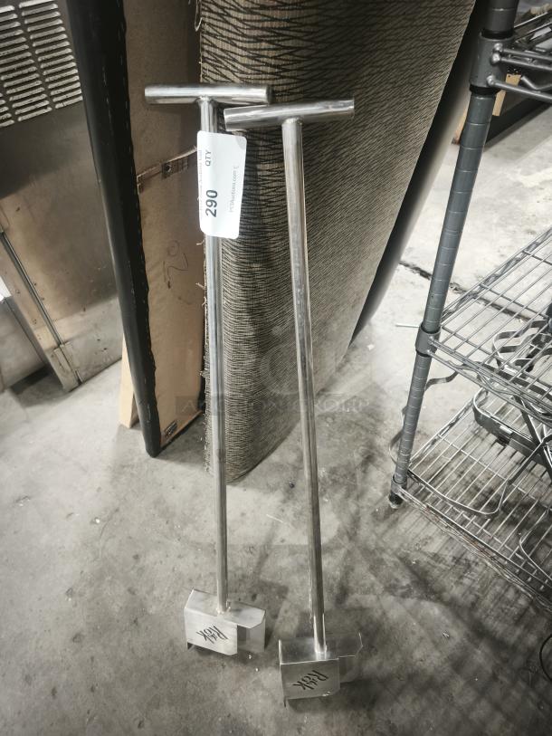 Two metal rock shovels for steak stones by Black Rock Grill, featuring T-shaped handles and engraved branding.