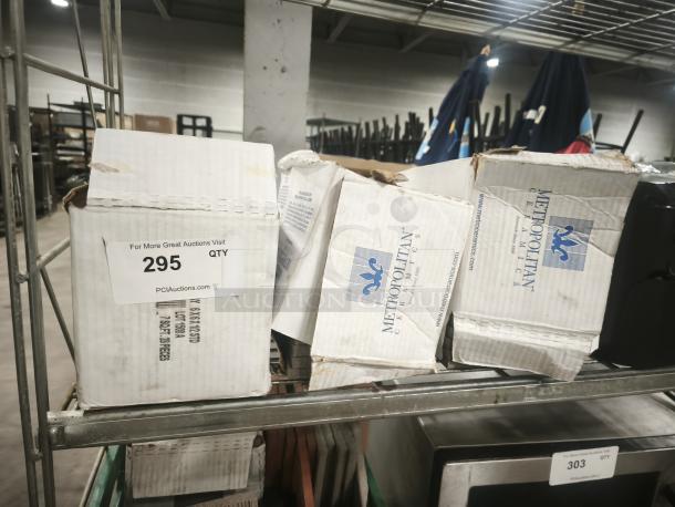 Boxes of brand new Metropolitan Ceramics tiles on a metal shelf, showing brand labels and auction lot number 295.