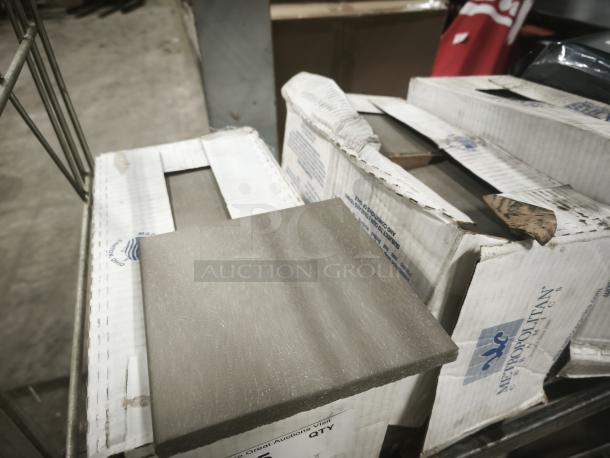 Brand new Metropolitan Ceramics tiles in boxes, gray color, pristine condition, original packaging with brand logo visible.