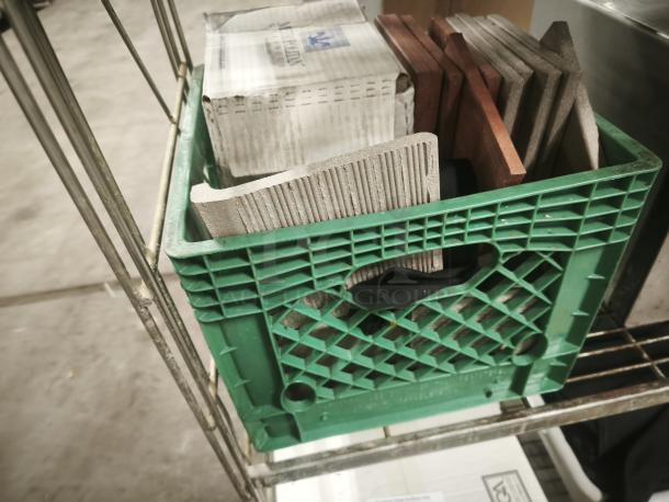 Brand new Metropolitan Ceramics tiles in a green crate, showcasing various colors and textures, with original packaging visible.
