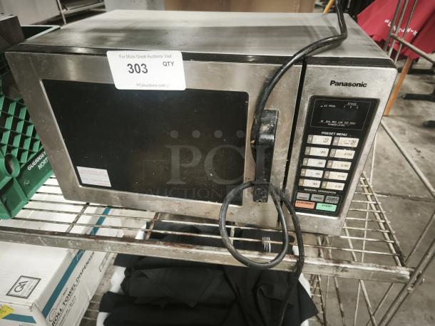 Panasonic NE-1054F commercial microwave oven, stainless steel finish, visible keypad, used condition, auction tag 303.