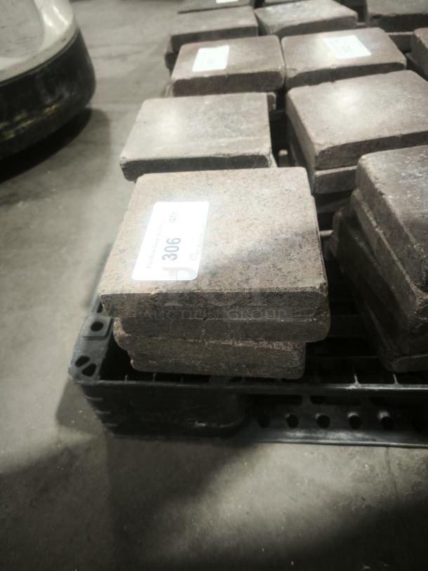 NSF certified volcanic granite tiles for cooking, stacked on a pallet. Quantity label reads "306 QTY."