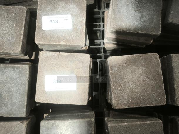 NSF certified volcanic granite cooking stones, square shape, stacked, visible auction tags with lot numbers 313 and 314.
