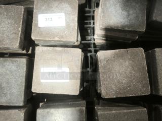 NSF certified volcanic granite cooking stones, square shape, stacked, visible auction tags with lot numbers 313 and 314.