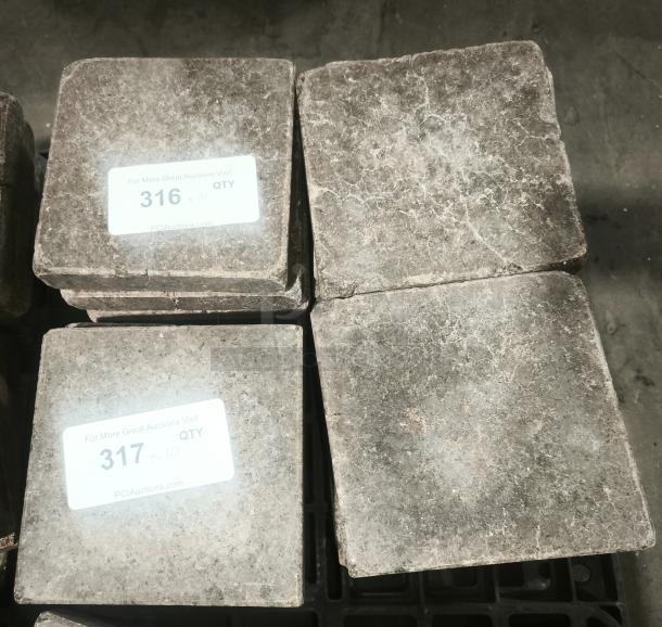 NSF certified volcanic granite cooking stones, stacked, rough texture. Labels show lot numbers 316 and 317 for auction.