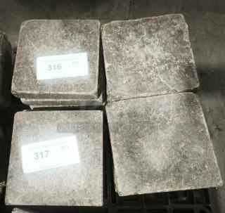 NSF certified volcanic granite cooking stones, stacked, rough texture. Labels show lot numbers 316 and 317 for auction.