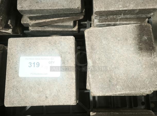 NSF certified volcanic granite slabs for cooking, stack of stone tiles with auction label, excellent condition.