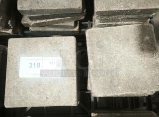 NSF certified volcanic granite slabs for cooking, stack of stone tiles with auction label, excellent condition.