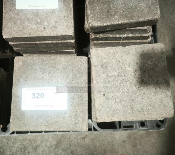 NSF certified volcanic granite slabs for food cooking, quantity of 10, in good condition. Marked with auction tag "320".