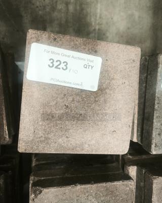 NSF certified volcanic granite slab for cooking, showing uneven gray tones and visible label with auction details.