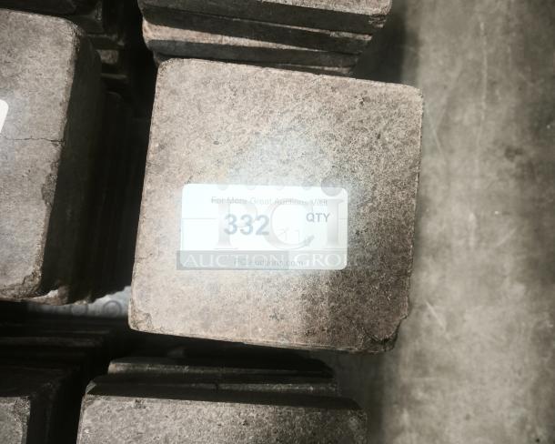 NSF certified volcanic granite slab for cooking, featuring rugged texture and visible label with auction details.
