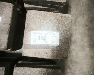 NSF certified volcanic granite slab for cooking, featuring rugged texture and visible label with auction details.