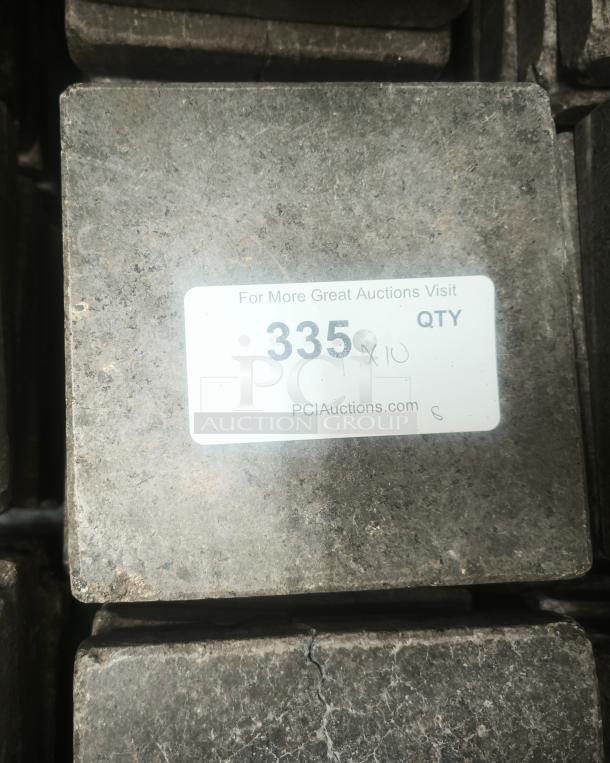 NSF certified volcanic granite slab for cooking, used, dark surface, label with text "335 x 10" and PCI Auctions website.