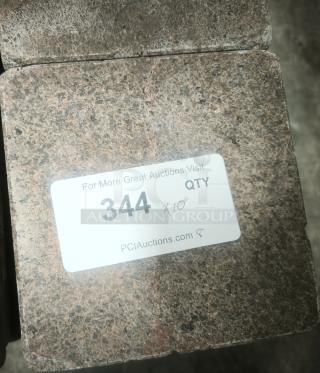 NSF Certified volcanic granite slab for cooking, textured surface, label reads "344 x10" from PCIAuctions.com.