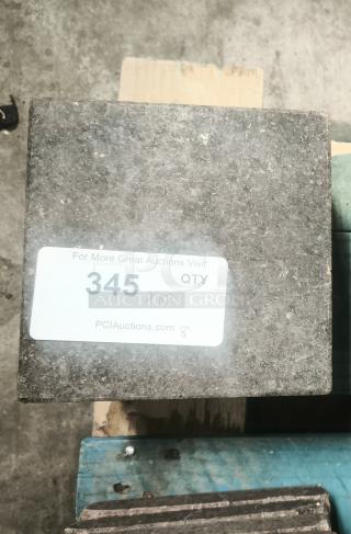 NSF certified volcanic granite slab for cooking, gray with visible label from PCI Auctions, in excellent condition.
