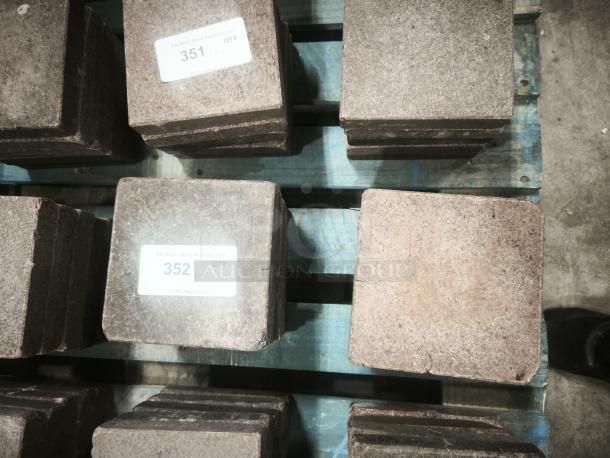 NSF certified volcanic granite slabs, suitable for cooking, displayed on a pallet. Tags indicate lot numbers 351 and 352.