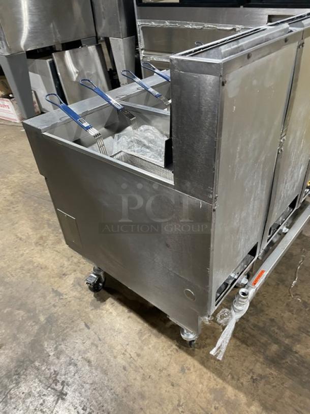 Pitco SG14-JS commercial stainless steel deep fryer, natural gas, 40 lb capacity, digital control, triple-bay, on casters.