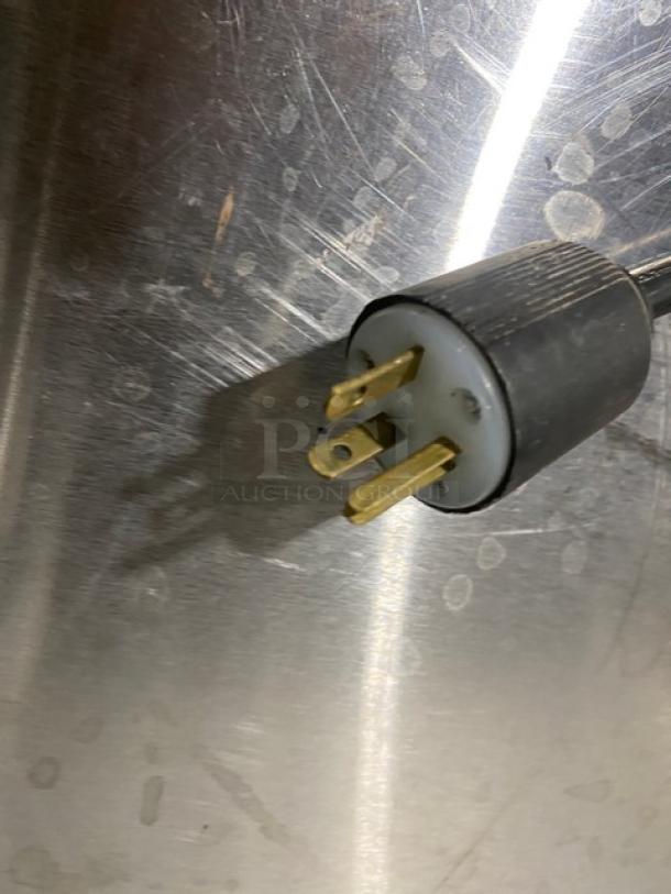 Close-up of a three-prong plug for the Robot Coupe R602V.V.F food processor, showing standard electrical connection pins.